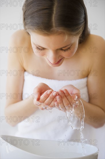 Woman washing face. 
Photo : Jamie Grill