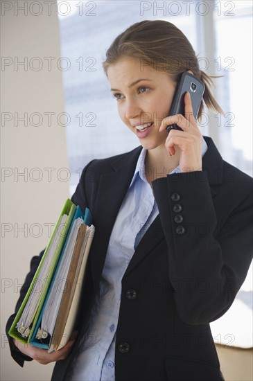 Businesswoman talking on cell phone. 
Photo : Jamie Grill