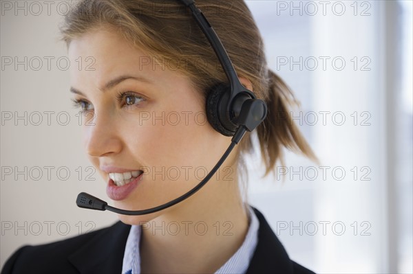 Customer service representative with headset. 
Photo: Jamie Grill