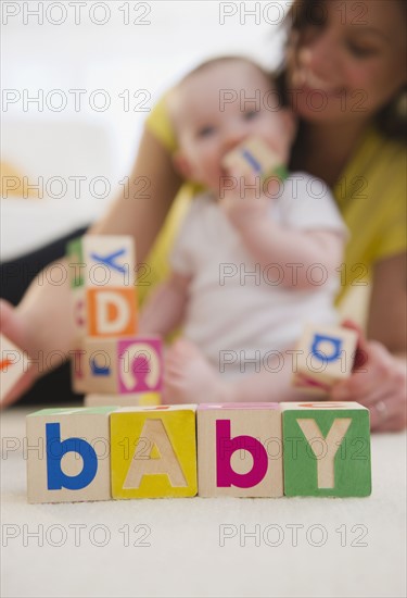 Mother and baby daughter (6-11 months) playing with blocks. 
Photo: Jamie Grill
