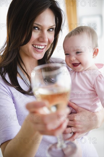 Mother with baby daughter (6-11 months) making toast. 
Photo: Jamie Grill