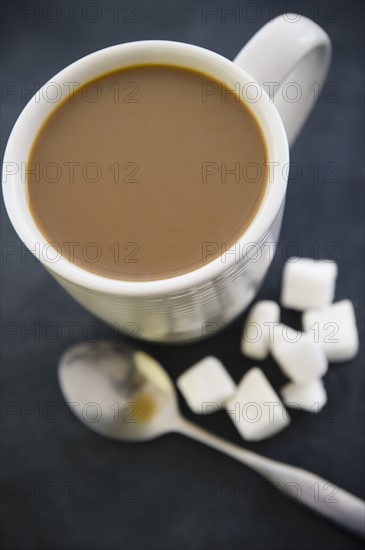 Close up of coffee cup and sugar cubes. 
Photo: Jamie Grill