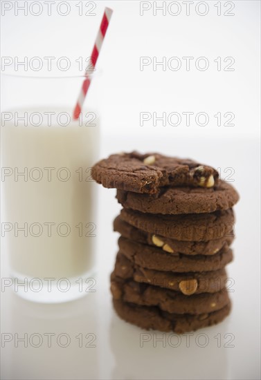 Close up of glass of milk and chocolate cookies. 
Photo : Jamie Grill