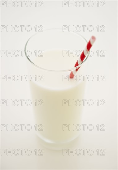 Close up of glass of milk with straw. 
Photo : Jamie Grill