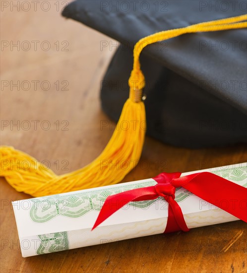 Close up of diploma and mortarboard, studio shot. 
Photo: Daniel Grill