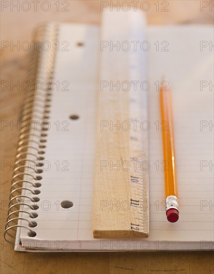 Close up of notebook, ruler and pencil, studio shot. 
Photo : Daniel Grill