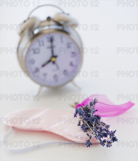 Close up of lavender, alarm clock and sleep masks, studio shot. 
Photo: Daniel Grill