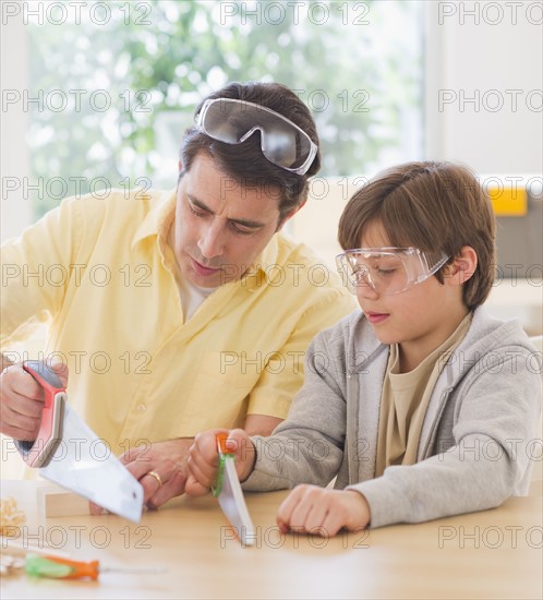 Father sewing wood with son (10-11 years). 
Photo: Daniel Grill