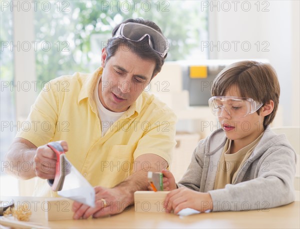 Father sewing wood with son (10-11 years). 
Photo: Daniel Grill