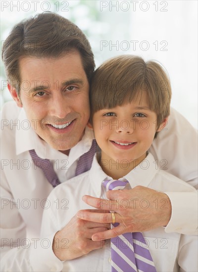 Father helping son (10-11 years) to tie tie. 
Photo : Daniel Grill