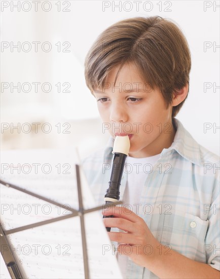 Boy (10-11 years) playing flute. 
Photo: Daniel Grill