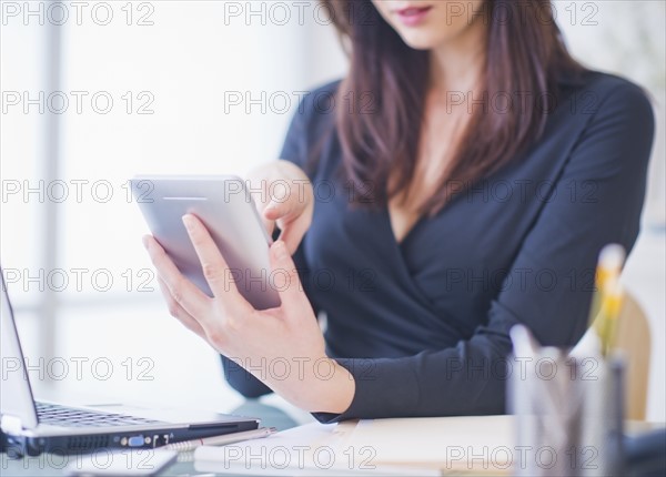 Businesswoman using digital tablet. 
Photo: Daniel Grill