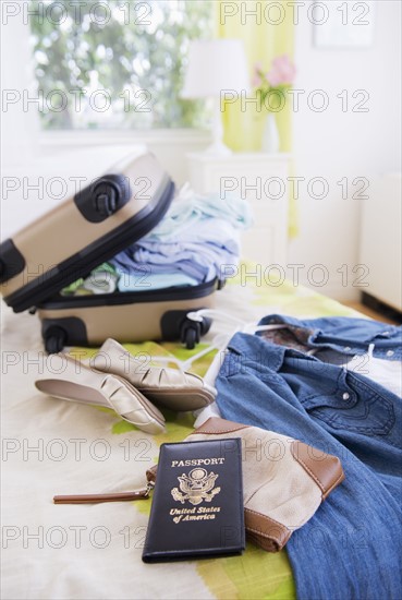 Suitcase and passport on bed during packing. 
Photo : Daniel Grill