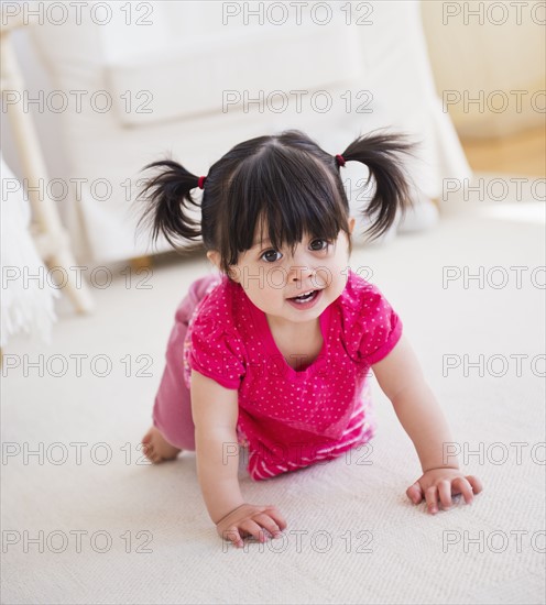 Baby girl (12-17 months) crawling on carpet. 
Photo: Daniel Grill