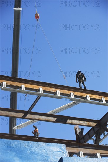 Construction workers on construction frame. 
Photo : fotog