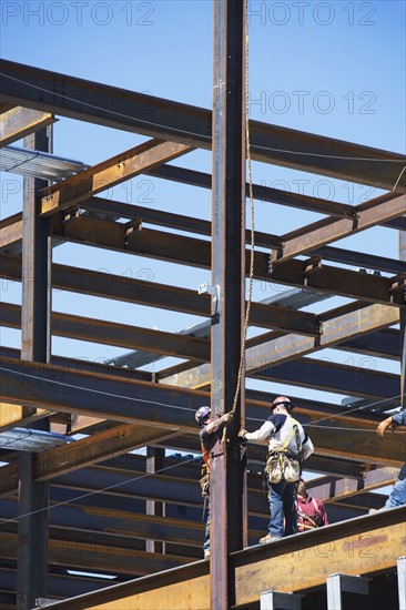 Construction workers on construction frame. 
Photo : fotog