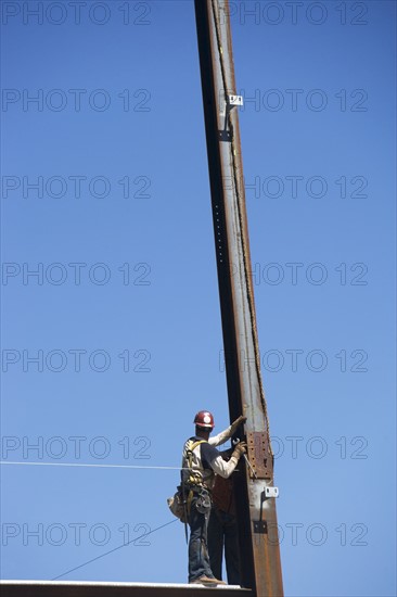 Construction workers on construction frame. 
Photo : fotog