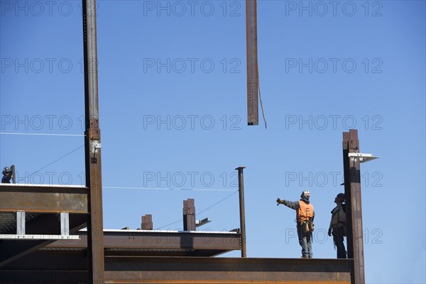 Construction workers on construction frame. 
Photo: fotog