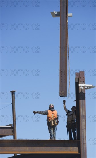 Construction workers on construction frame. 
Photo : fotog