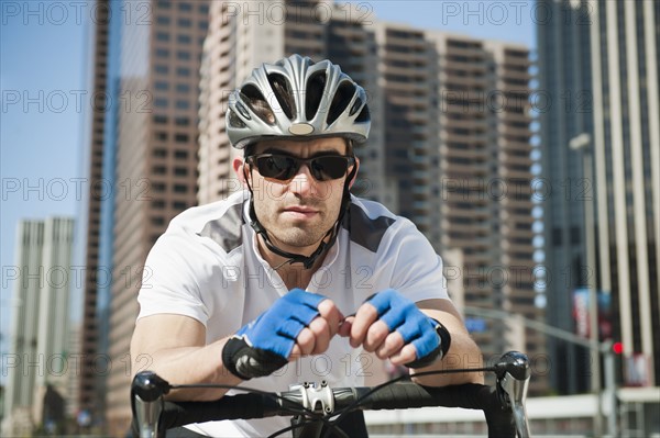 USA, California, Los Angeles, Portrait of young man road cycling on city street.