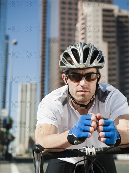 USA, California, Los Angeles, Portrait of young man road cycling on city street.