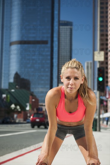 USA, California, Los Angeles, Young woman resting after running on city street. 
Photo: Erik Isakson