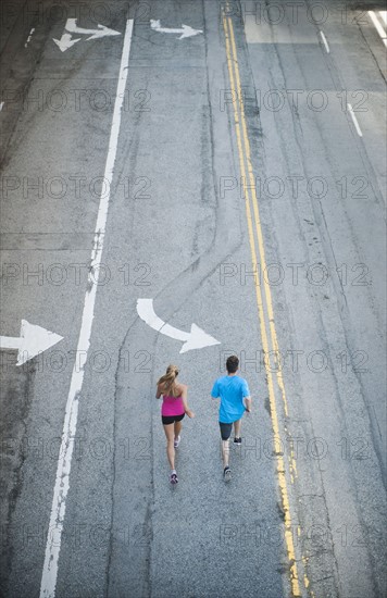 USA, California, Los Angeles, Elevated view of man and woman running on street. 
Photo: Erik Isakson