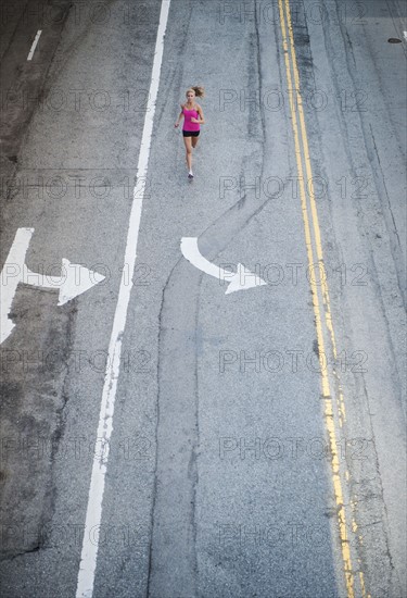 USA, California, Los Angeles, Elevated view of woman running on street.