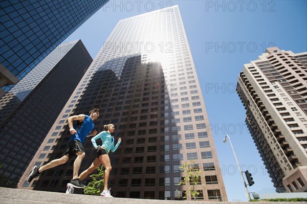 USA, California, Los Angeles, Young man and young woman running in city. 
Photo: Erik Isakson