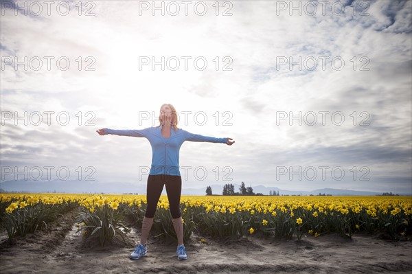 USA, Washington, Skagit Valley, Woman exercising in rural area. 
Photo: Take A Pix Media