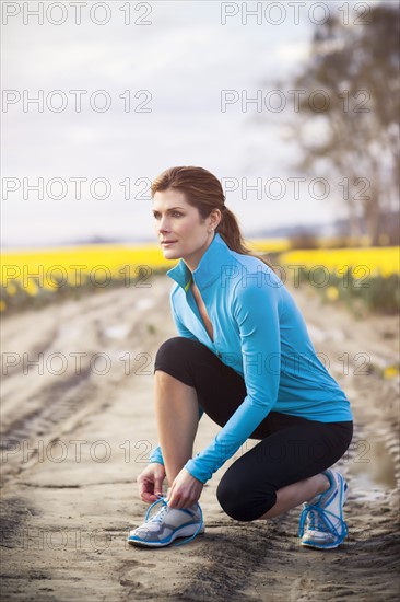 USA, Washington, Skagit Valley, Woman exercising in rural area. 
Photo: Take A Pix Media