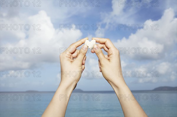 United States Virgin Islands, St. John, Heart-shaped stone in female hands. 
Photo : Winslow Productions