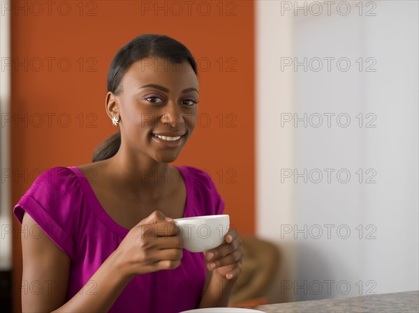 Young woman with cup of coffee. 
Photo : Dan Bannister