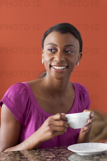 Young woman enjoying morning coffee. 
Photo : Dan Bannister