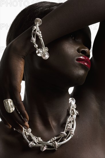 Portrait of young woman in necklace. 
Photo : Jan Scherders