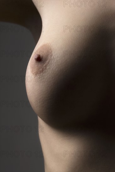 Naked female breast. 
Photo : Jan Scherders
