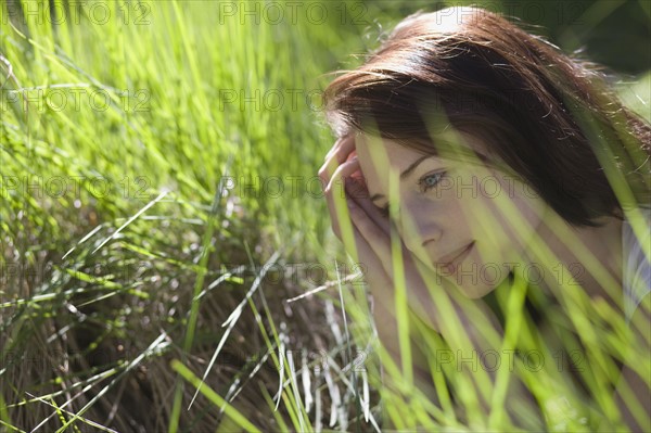 Young woman among green grass. 
Photo: Jan Scherders