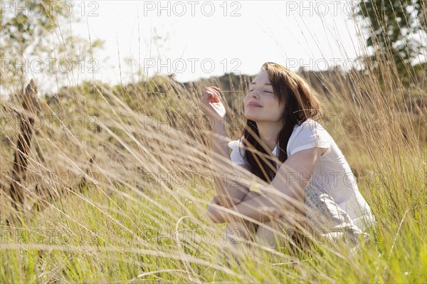 Young woman relaxing on meadow. 
Photo : Jan Scherders