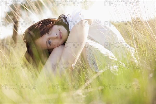 Young woman relaxing on meadow. 
Photo : Jan Scherders