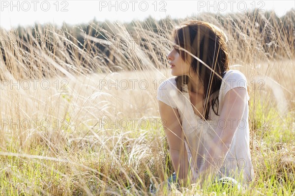 Young woman relaxing on meadow. 
Photo : Jan Scherders