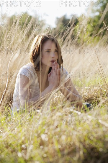 Young woman relaxing on meadow. 
Photo : Jan Scherders