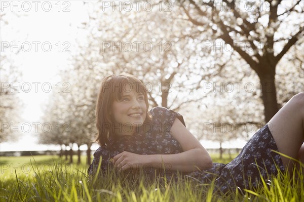 Belgium, Sint-Truiden, Portrait of young woman in spring orchard. 
Photo : Jan Scherders