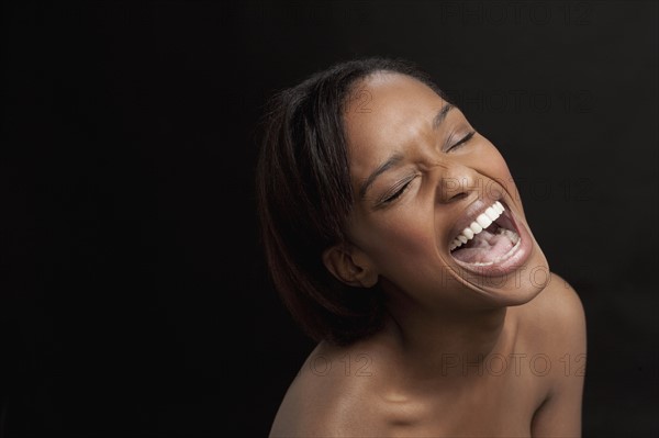 Young woman bursting with laugh. 
Photo : Jan Scherders
