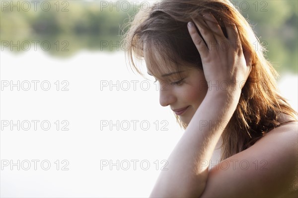 Young woman running head through hair. 
Photo : Jan Scherders