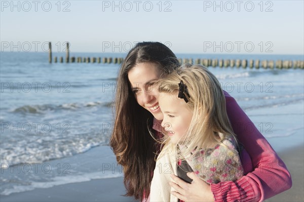 Netherlands, Zeeland, Haamstede, Mother with daughter on beach. 
Photo : Jan Scherders