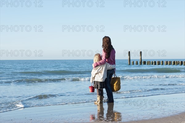 Netherlands, Zeeland, Haamstede, Mother with daughter on beach. 
Photo : Jan Scherders