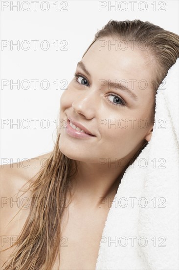 Portrait of young woman with wet hair and towel. 
Photo: Jan Scherders
