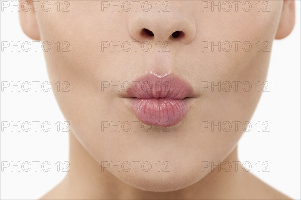 Close-up of female lips blowing kiss. 
Photo : Jan Scherders