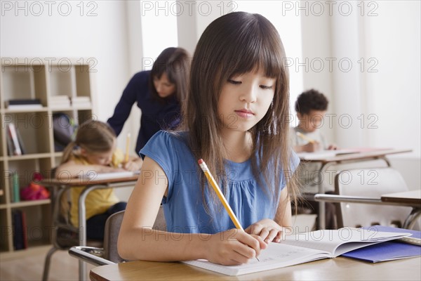 Schoolgirl focused on writing. 
Photo: Rob Lewine