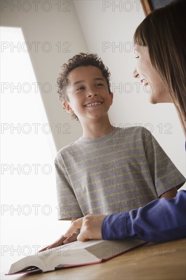 Schoolboy reading with teacher in classroom. 
Photo : Rob Lewine